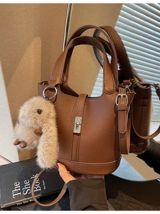Vintage brown lychee grain leather bucket bag with top handles and plush bunny charm