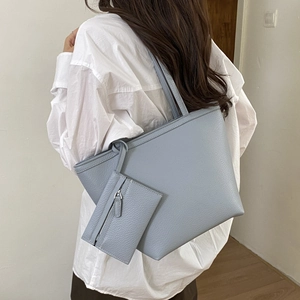 Light blue large capacity tote bag with lychee texture leather on female model