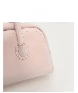 Detail shot of pink bowling bag showing reinforced stitching and premium leather texture