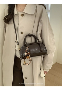 Deep brown glossy Boston bag with vintage texture and decorative beads chain detail