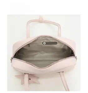 Interior view of pink bowling handbag showing grey lining and zipper storage pocket
