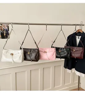 Detailed row of tote bags in cream, caramel, pink, black and burgundy leather