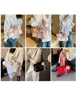 Detail of glossy PU leather tote bag with pleated texture and teddy bear pendant accessory