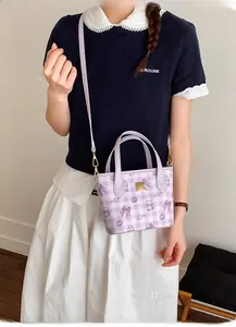 Detail of light purple checkered mini tote bag with cute bow and bear patterns