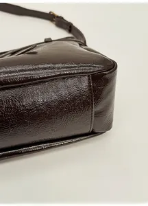 Detailed close-up of the vintage dark brown tote bag base showing stitching and texture