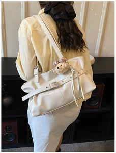 White glossy faux leather tote bag with silver buckle and cute plush bear charm detail