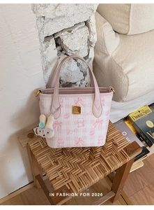 Detail of pink plaid tote bag with cute cartoon bear prints and rabbit plush charm