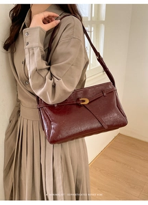 Close-up of retro wine red tote with oil wax finish and elegant gold twist lock detail