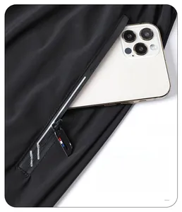 Detail of running pants featuring a secure zipper pocket holding a large smartphone
