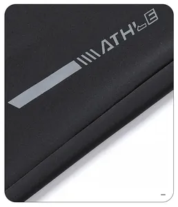 Detail of high-temperature heat-sealed ATHLE logo on black quick-dry pants fabric