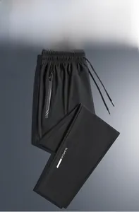 Detail view of men's quick-dry sports pants with drawstring waist and zipper pocket