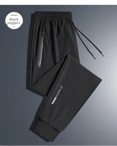 Detail of black quick-dry jogger with zipper pocket and reflective trim on ice silk fabric