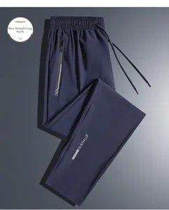 Detail of navy blue quick-dry ice silk pants with elastic waist and zippered pockets