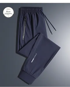Macro shot of men's quick-dry joggers with reflective zipper pocket and elastic drawstring