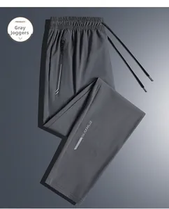 Close-up of grey quick-dry ice silk sport pants with elastic waist and zipper pockets