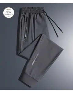 Detail of grey ice silk joggers showing elastic waist with drawstring and zip pocket
