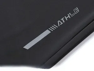 Detailed macro view of the ATHLE letter logo and gray decorative stripes on black fabric