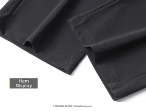 Detailed close-up of double-stitched hem on quick-dry black outdoor sport pants
