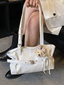 Glossy white faux leather tote bag with silver buckles and a cute bear charm accessory