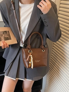 Chic brown crossbody bucket bag for women with vintage beaded charm and top handles