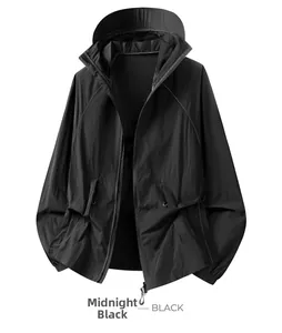 Detail of a black sun protection jacket featuring elastic cuffs and drawstring hem