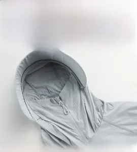 Detail of hooded sun protection jacket featuring breathable face mask and stiff brim