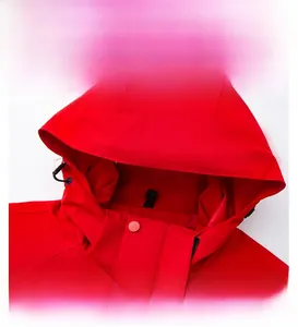 Detail of red windbreaker hood with adjustable black drawstring and reinforced wide brim