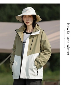 Detail of color-block outdoor jacket with hooded collar and waterproof fabric