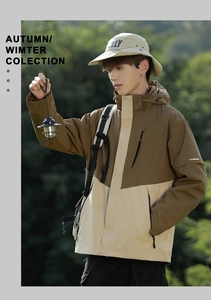 Detail of waterproof outdoor jacket featuring contrast stitching and hooded neck design