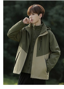Close-up of waterproof 3-in-1 hiking jacket featuring detachable fleece lining in nature