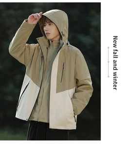 Detail of waterproof zippers and two-tone fabric on a hooded outdoor jacket