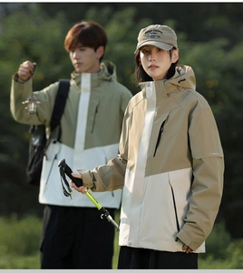 Detail of couple outdoor jacket with hood, windproof fabric and contrast stitching