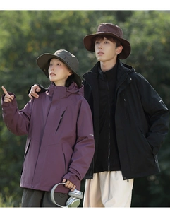 Outdoor waterproof jacket with adjustable cuffs and wide-brimmed embroidered hiking hat