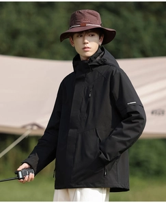 Detail of waterproof outdoor jacket sleeve with high collar and camping hat accent
