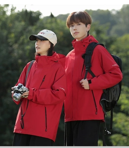 Detail of red waterproof 3-in-1 hiking jacket with adjustable cuffs and hood