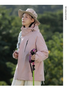 Close-up of pink hooded waterproof jacket with adjustable velcro cuffs and side pockets