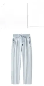 Detail of light blue ice silk joggers with zipper pockets and drawstring waist