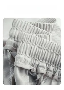 Close-up of elastic waistband with detailed stitching on light gray quick-dry pants