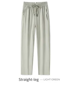 Detail of light green quick-dry hiking pants with drawstring waist and zipper pockets