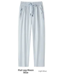 Detail of light blue quick-dry sports pants with elastic drawstring waist and zipper pockets