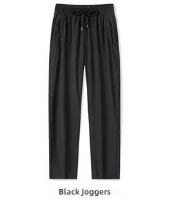 Detail of black quick-dry pants featuring elastic waist with drawstring and zip pockets