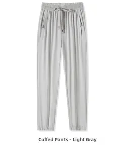 Macro detail of light gray quick-dry jogger pants with elastic drawstring waist and zipper pocket