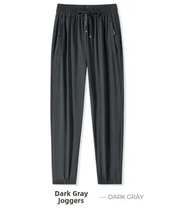 Detail of dark gray ice silk sweatpants with drawstring waist and zip pockets