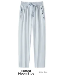 Detail view of moon blue ice silk pants showing drawstring waist and zipper pockets