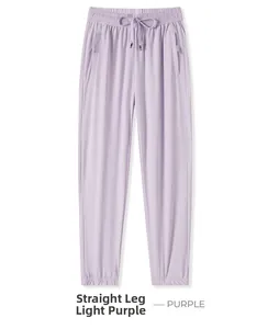 Detail of light purple quick-dry pants featuring elastic drawstring waist and zipper pockets
