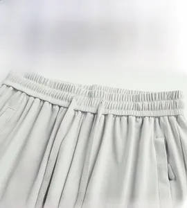 Detail of elastic waist with adjustable drawstring and texture on gray hiking pants