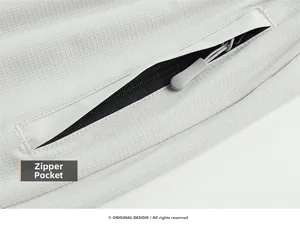 Detail of grey ice silk sport pants featuring a zipper pocket and durable ripstop texture