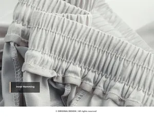 Detail of grey sports pants showing elastic waistband and high-quality inner piping