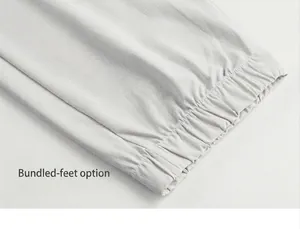Close-up of light grey ripstop fabric and elasticated jogger cuffs on quick-dry pants
