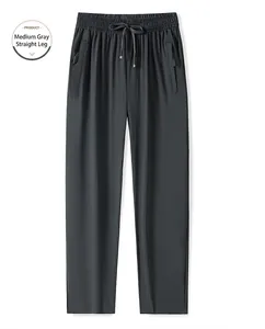 Détail du pantalon gris moyen en soie glacée avec taille à cordon et poches zippées sûres
